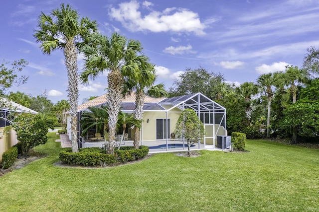 back of house featuring central air condition unit, glass enclosure, a lawn, and a pool