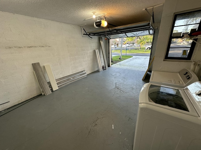 garage with a garage door opener and washing machine and clothes dryer