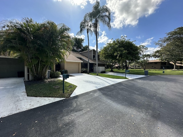 view of front of property featuring a garage and a front lawn