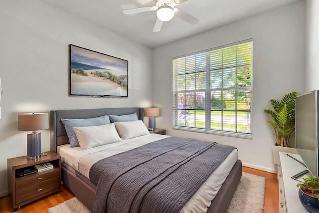 bedroom with light wood finished floors and ceiling fan