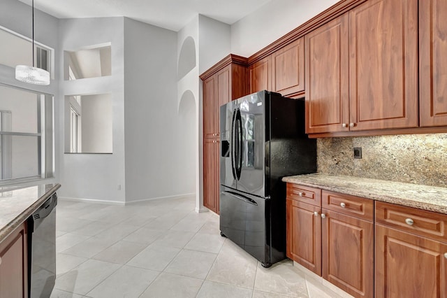 kitchen featuring light tile patterned floors, dishwasher, black fridge with ice dispenser, light stone counters, and backsplash