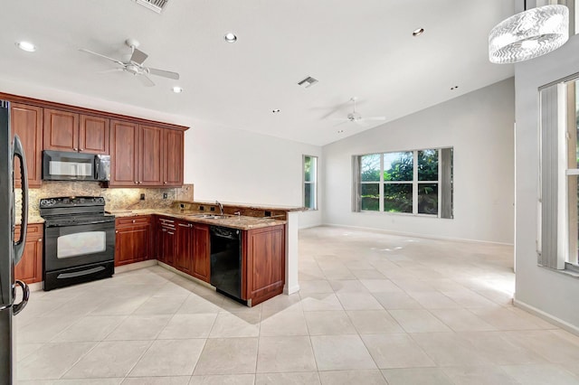 kitchen featuring light stone counters, a peninsula, a sink, black appliances, and tasteful backsplash