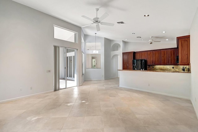 unfurnished living room with high vaulted ceiling, visible vents, arched walkways, and a ceiling fan