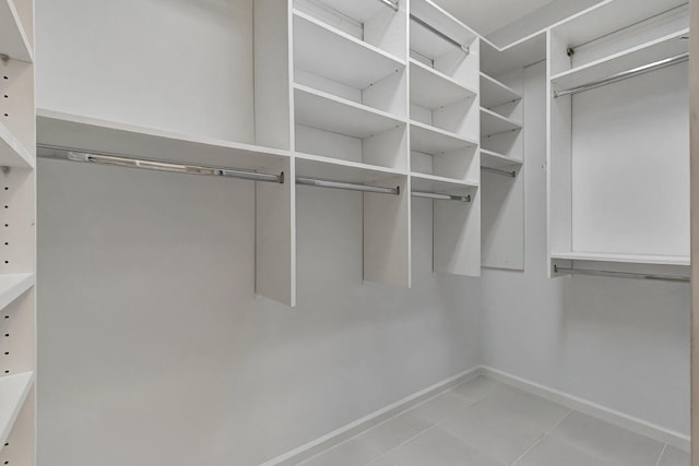 spacious closet with light tile patterned floors