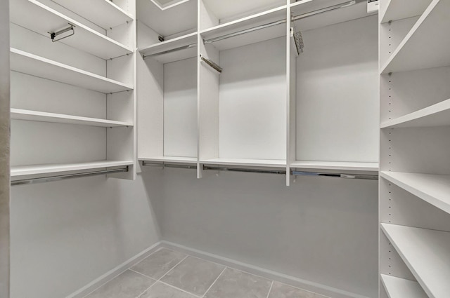 walk in closet featuring light tile patterned floors