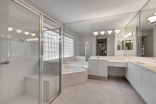 full bath with a bath, a stall shower, tile patterned flooring, and vanity