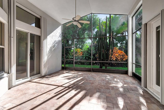 unfurnished sunroom with a ceiling fan