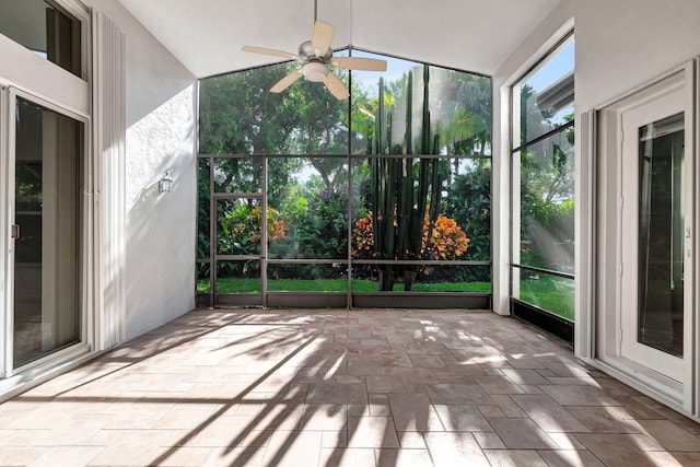 unfurnished sunroom with ceiling fan