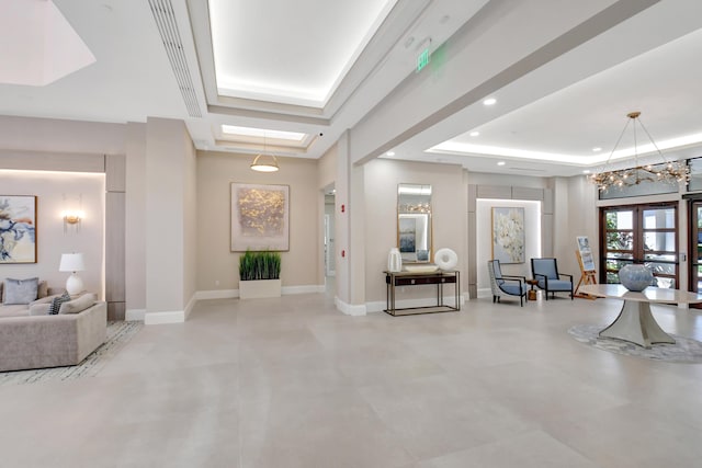 entrance foyer with recessed lighting, baseboards, a tray ceiling, and french doors