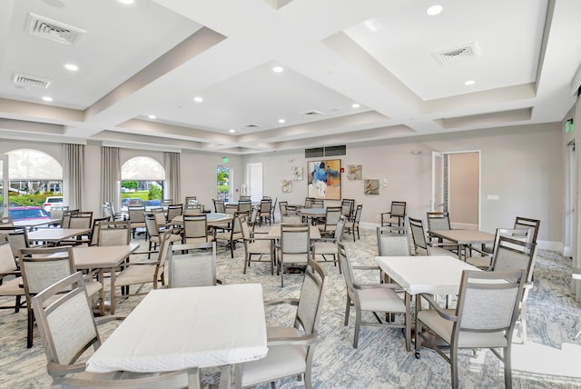 dining area featuring coffered ceiling and visible vents