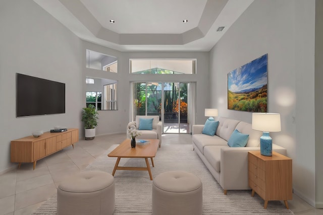 living room featuring baseboards, a high ceiling, and light tile patterned floors