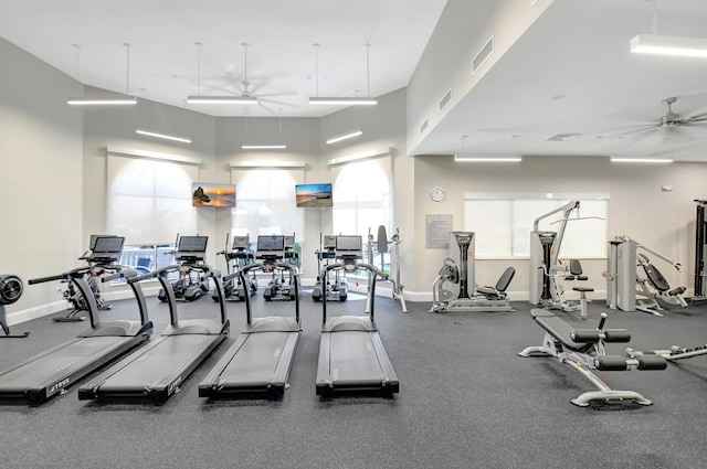 gym featuring ceiling fan, visible vents, and baseboards