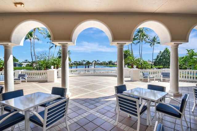 view of patio with outdoor dining space and a water view