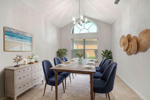 dining area with light tile patterned floors, baseboards, visible vents, vaulted ceiling, and a chandelier