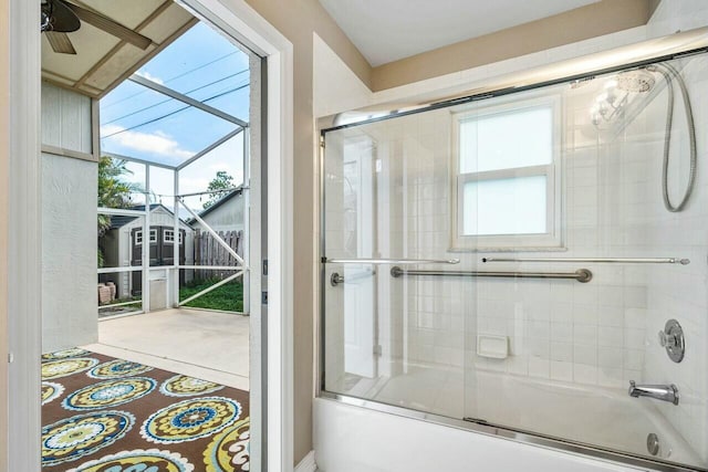 bathroom featuring bath / shower combo with glass door and ceiling fan