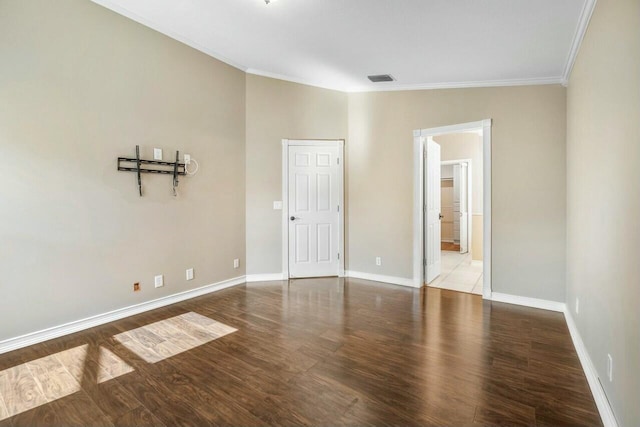 spare room with ornamental molding and wood-type flooring