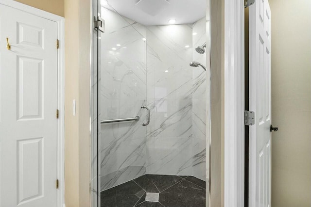 bathroom featuring a shower with door