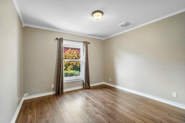 spare room featuring ornamental molding and light hardwood / wood-style flooring