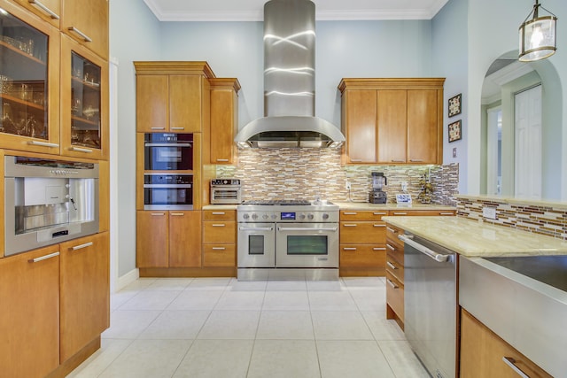 kitchen with stainless steel appliances, wall chimney range hood, backsplash, light tile patterned floors, and ornamental molding