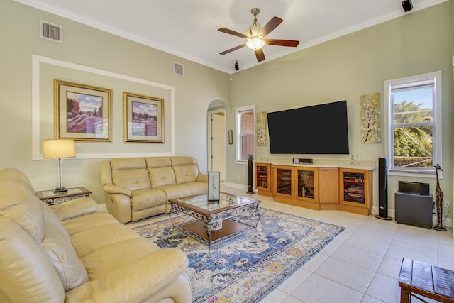 living room featuring light tile patterned floors, ceiling fan, and ornamental molding