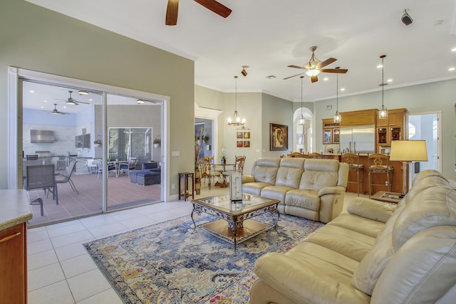 tiled living room with crown molding and a chandelier