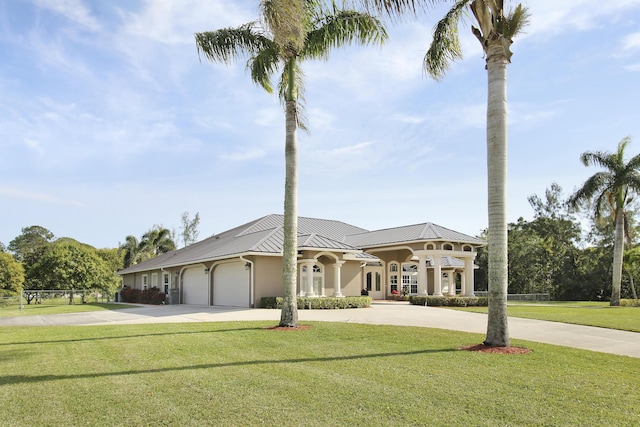 view of front of home featuring a garage and a front yard