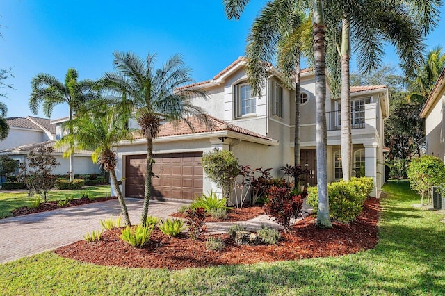 mediterranean / spanish-style house with a balcony and a front yard