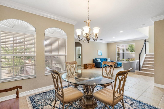 tiled dining space with a notable chandelier and ornamental molding