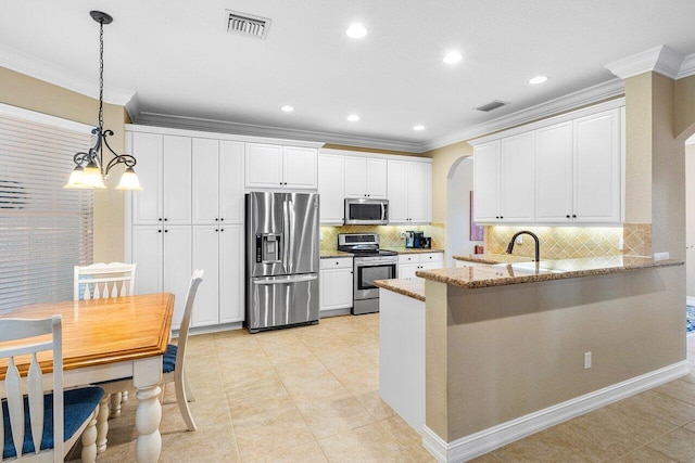 kitchen with white cabinetry, light stone countertops, stainless steel appliances, kitchen peninsula, and crown molding