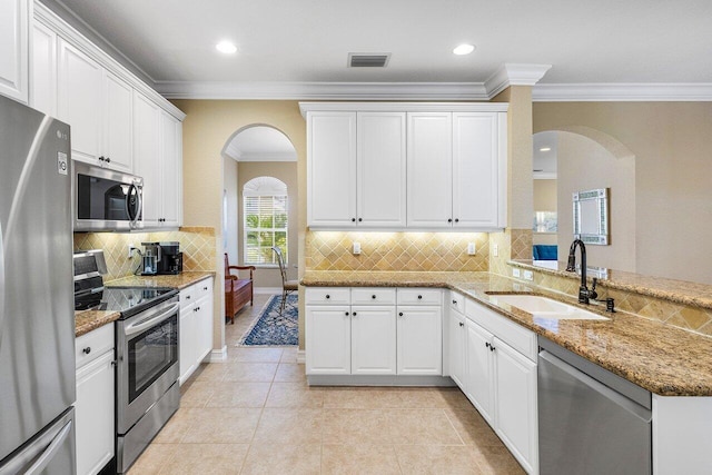 kitchen featuring kitchen peninsula, stainless steel appliances, white cabinetry, and sink