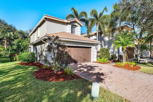 mediterranean / spanish-style house featuring a garage and a front lawn