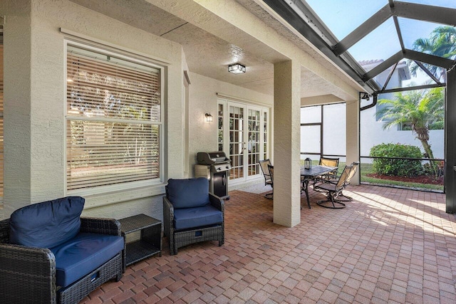 view of patio featuring area for grilling and a lanai