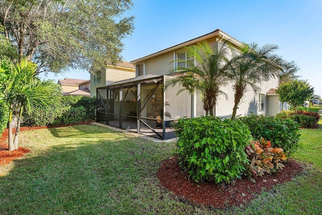 rear view of house featuring a yard