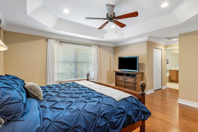 bedroom featuring a tray ceiling, ceiling fan, hardwood / wood-style floors, and ornamental molding