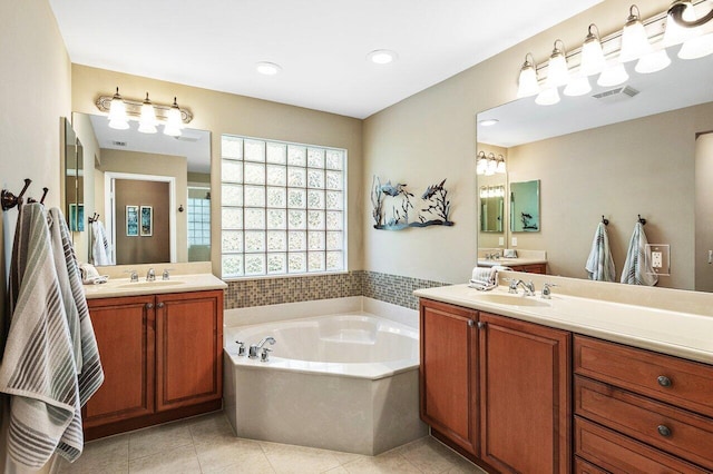 bathroom featuring tile patterned floors, vanity, and shower with separate bathtub