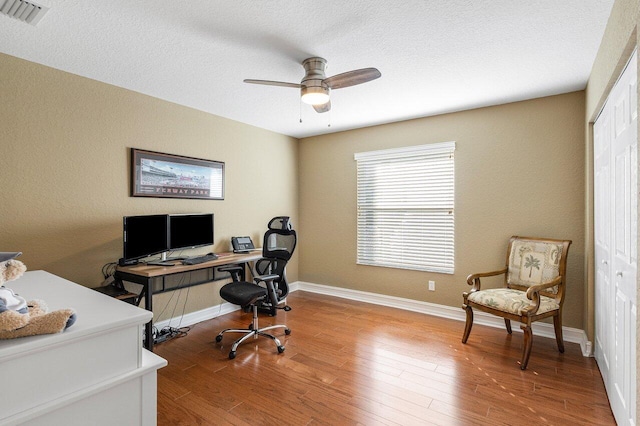 office space with wood-type flooring and ceiling fan