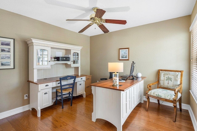 home office with hardwood / wood-style floors and ceiling fan