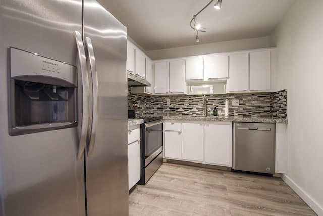 kitchen featuring white cabinetry, sink, stainless steel appliances, light stone counters, and light hardwood / wood-style floors