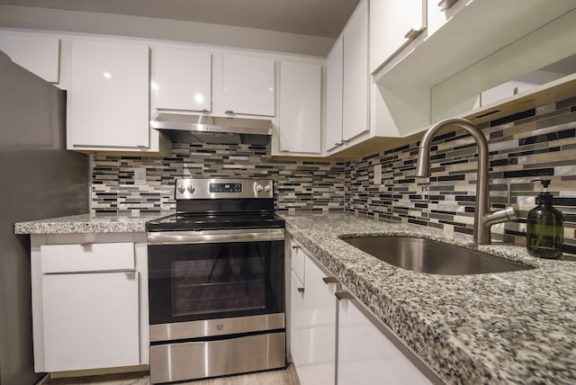 kitchen with decorative backsplash, sink, white cabinets, and stainless steel appliances