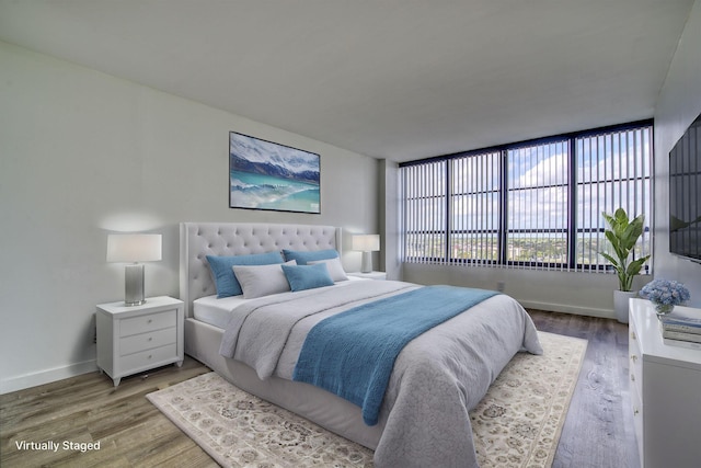 bedroom with hardwood / wood-style flooring