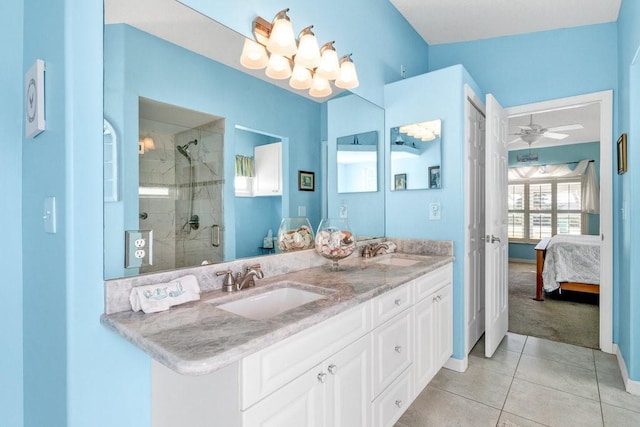 bathroom with tile patterned floors, ceiling fan, a shower with door, and vanity