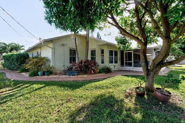 rear view of property with a yard