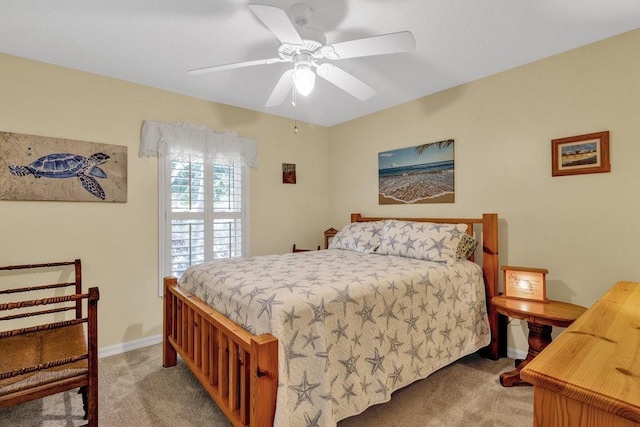 bedroom with ceiling fan and light colored carpet