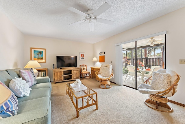 living room with ceiling fan, a textured ceiling, baseboards, and carpet flooring