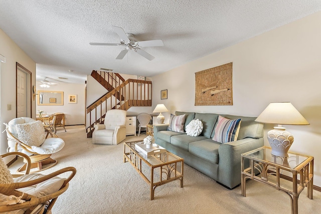 living room with light carpet, ceiling fan, stairs, and a textured ceiling