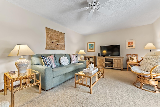 living room with ceiling fan, a textured ceiling, and light colored carpet