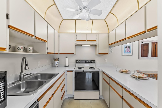 kitchen with under cabinet range hood, electric range, light countertops, and a sink