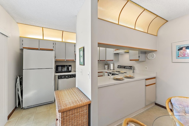 kitchen featuring a textured ceiling, under cabinet range hood, white appliances, baseboards, and light countertops