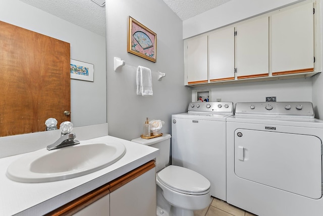 bathroom featuring toilet, a textured ceiling, vanity, independent washer and dryer, and tile patterned floors