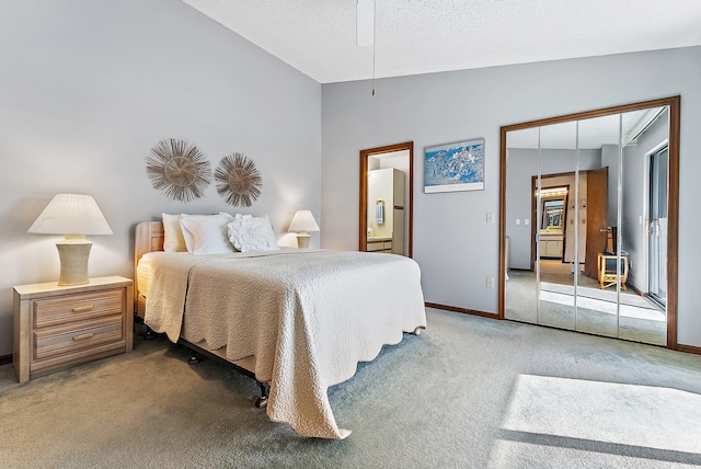 carpeted bedroom featuring lofted ceiling, connected bathroom, a textured ceiling, and baseboards